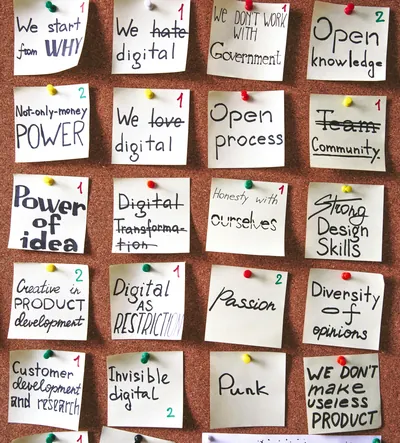 Pinboard with sticky notes from a change management workshop